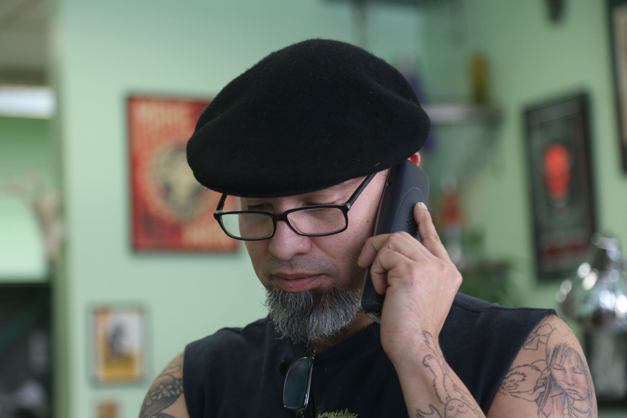 cesar on phone Medusa Tattoo Studio